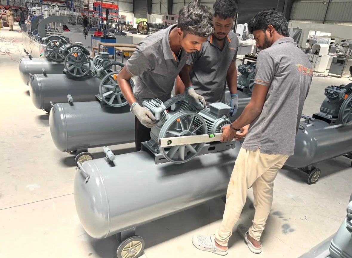 About Howzzat Impex 5 Technicians assembling air compressors for UPVC machines at Howzzat Impex